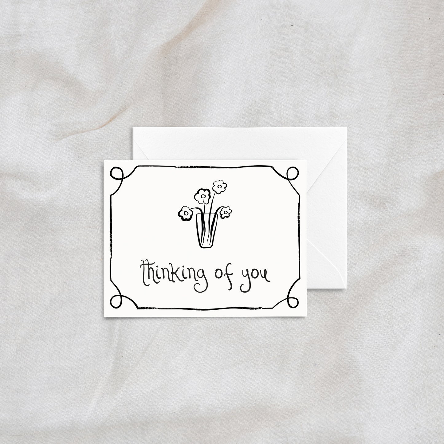 A charming "thinking of you" greeting card with a simple floral vase illustration and decorative border. Designed with clean line art and paired with a matching white envelope, this card is ideal for thoughtful and comforting notes.
