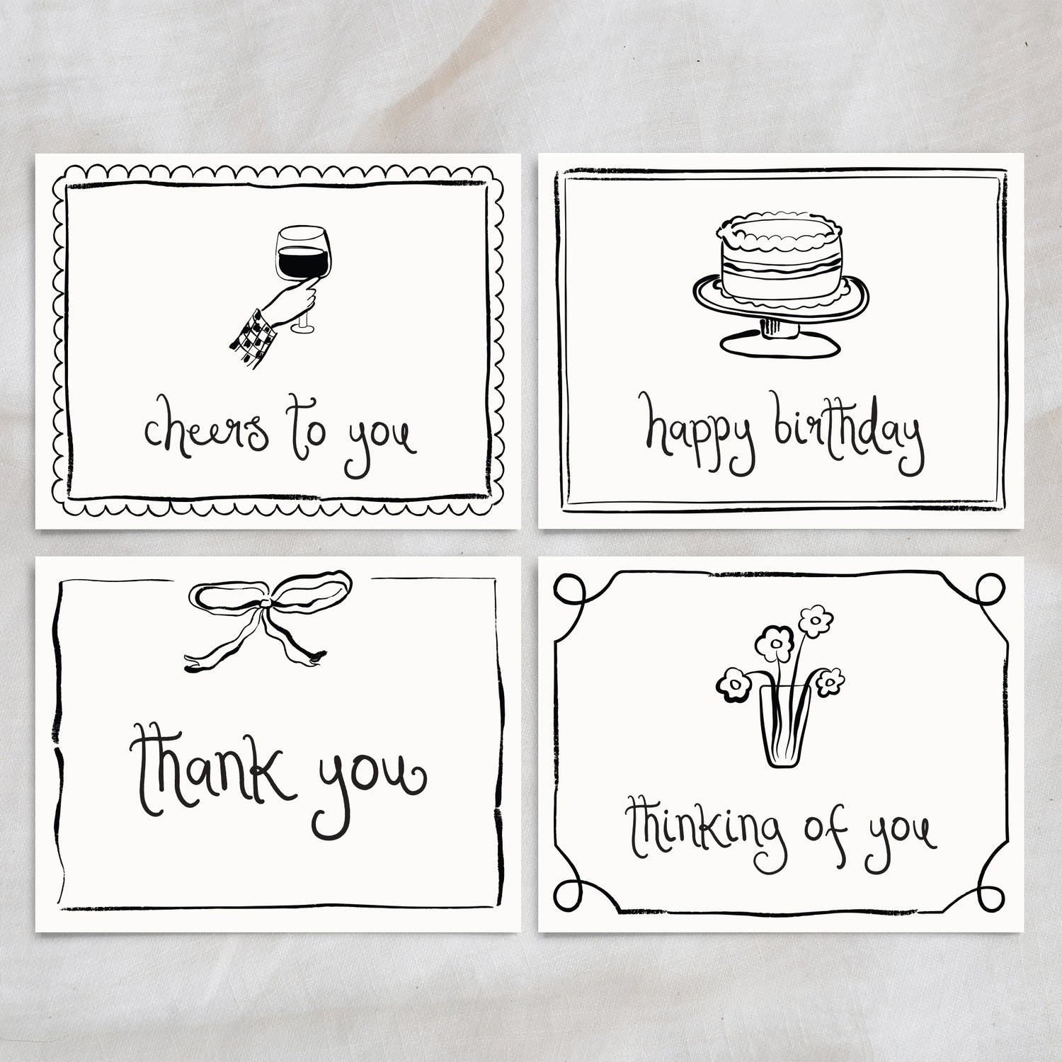 The Essentials Set, showcasing four elegant hand-drawn greeting cards: "cheers to you" with a wine glass, "happy birthday" with a cake, "thank you" with a bow, and "thinking of you" with a vase of flowers. This versatile card set is perfect for celebrations, gratitude, and thoughtful messages.