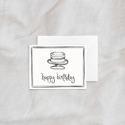 A modern and whimsical "happy birthday" greeting card showcasing a hand-drawn layered cake illustration. Designed with simple black line art and a matching white envelope, ideal for birthdays and special occasions.