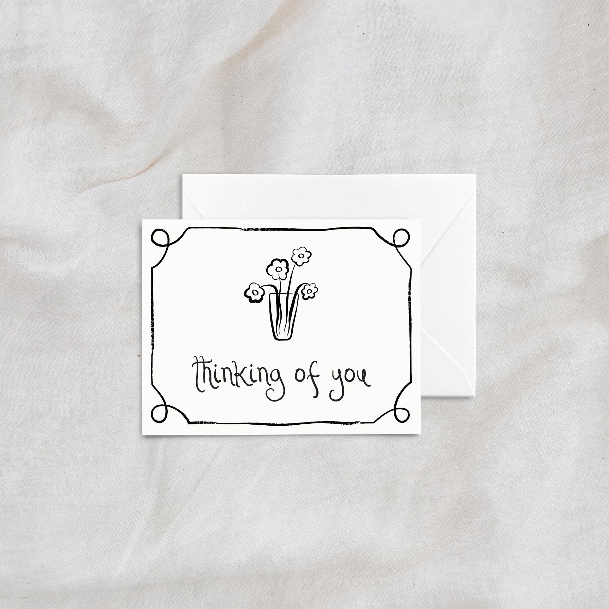 A charming "thinking of you" greeting card with a simple floral vase illustration and decorative border. Designed with clean line art and paired with a matching white envelope, this card is ideal for thoughtful and comforting notes.